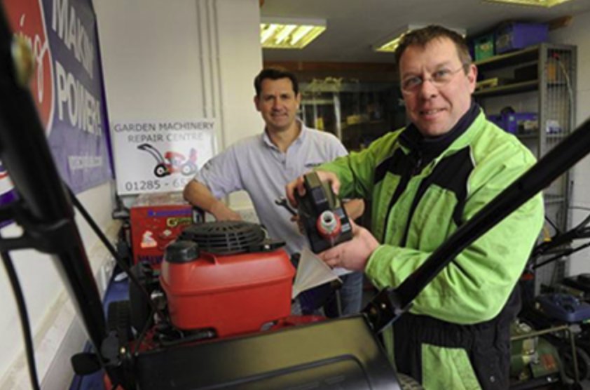 Cirencester Garden Machinery staff repairing a lawn mower in the workshop