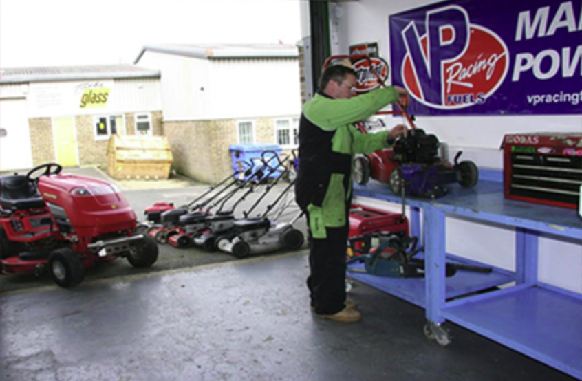 Lawn mowers lined up for servicing at the Cirencester workshop